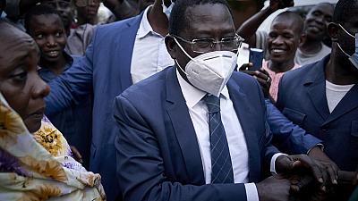 Late Malian politician Soumaila Cisse greets supporters as he arrives at his home in Bamako, on October 9, 2020, a day after his release