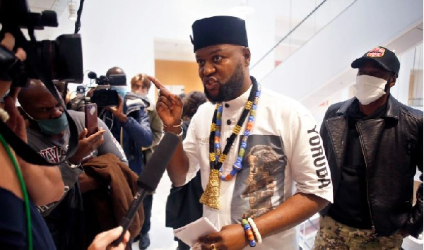 Congolese activist Mwazulu Diyabanza talks to the media at the Palais de Justice courthouse in Paris