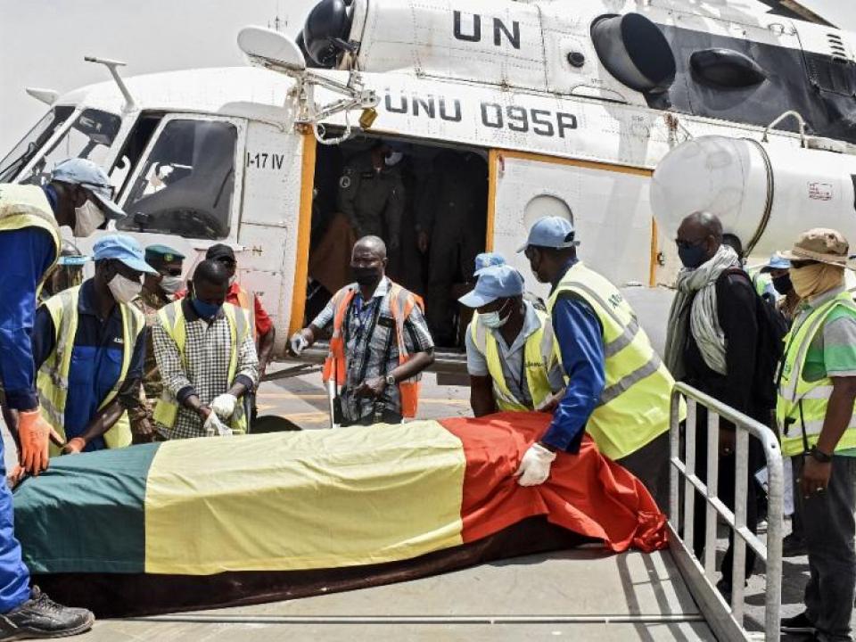 Men carry the coffin of Ould Sidati, president of the Co-ordination of Azawad Movements (CMA) onto a United Nations helicopter ahead of his burial in Timbuktu on April 16, 2021