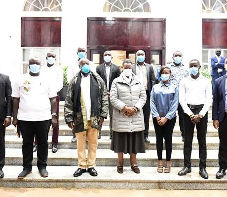 President Museveni, wife (c) posing with a group of youth whose Facebook account were closed