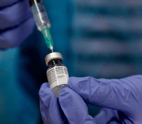 A medical health worker fills a syringe with the Covid-19 vaccine at Clalit Health Services center