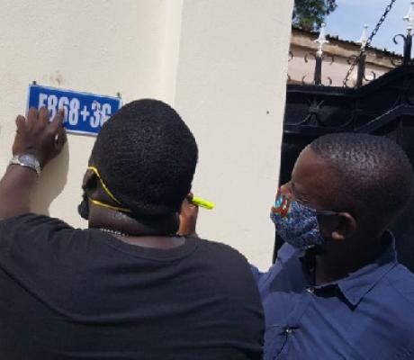 Bakary Suso (L) and Alieu Sowe, (R) are putting up the signs themselves