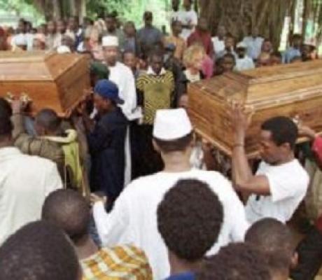 Flag-clad coffins holding the seven bodies headed towards the Festival square for burial