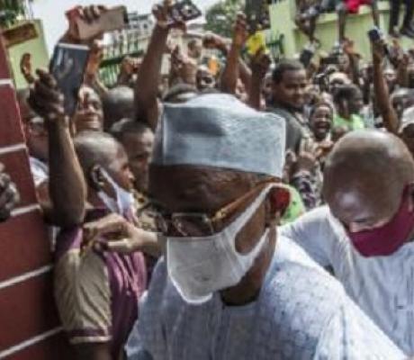 Guinean President Alpha Condé was guided through the crowd during his visit to the police officers