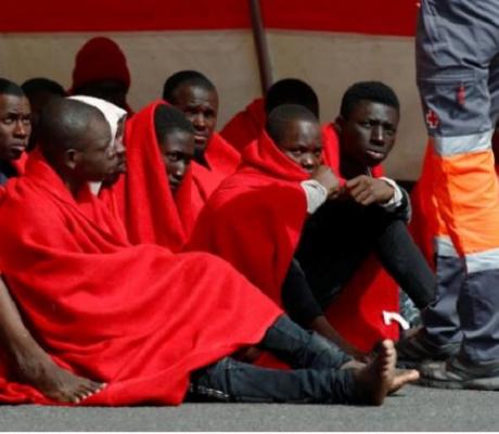 Migrants rescued in the Atlantic Ocean disembark from a Spanish coast