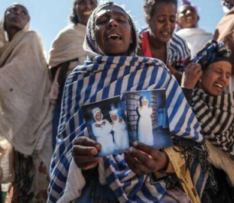 Women mourn the victims of a massacre allegedly perpetrated by Eritrean Soldiers