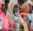 Families wait outside the port of Pemba on April 1, 2021, for the boat of evacuees from the coasts of Palma