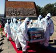 Pallbearers carry the coffin of late Zimbabwe's agriculture minister Perrance Shiri at his funeral